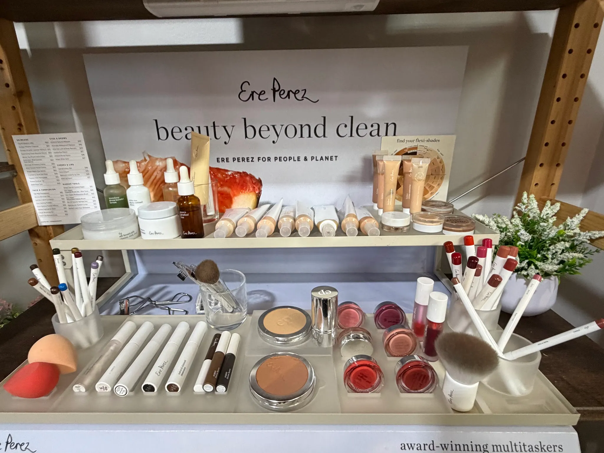 Ere Perez natural beauty display with skincare, makeup brushes and products on a tiered counter at Natural Balance