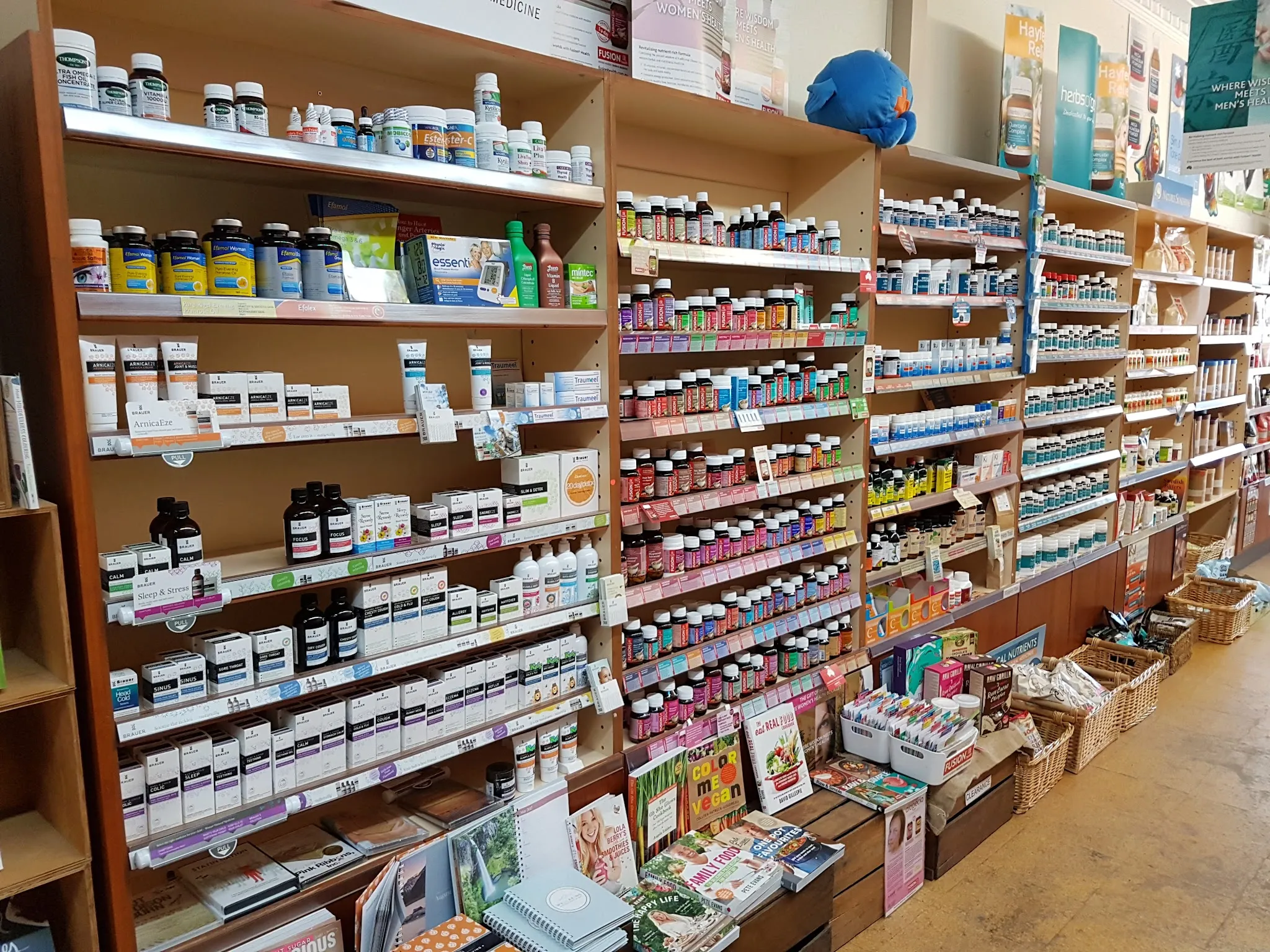 Floor-to-ceiling supplement shelving packed with hundreds of supplement and vitamin bottles at Natural Balance